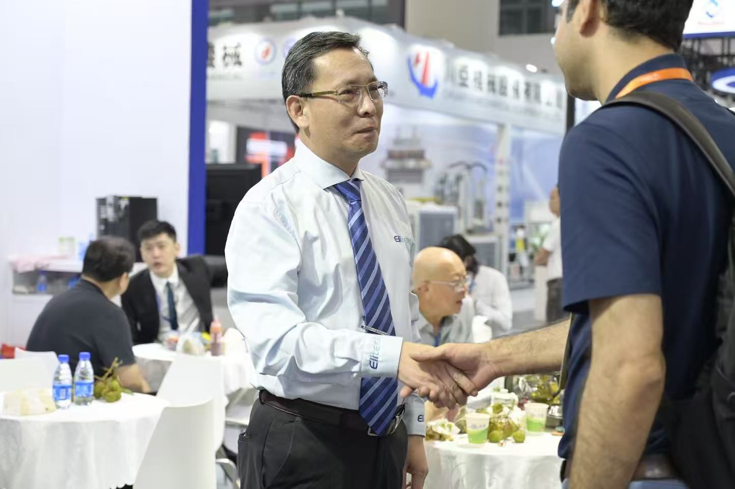 Elitech CEO George Chou demonstrating SP shoe machinery at Guangzhou Leather Fair